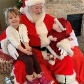 Children sit with Santa Clause.