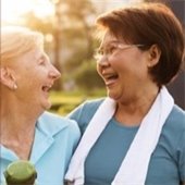 Two women laugh together.