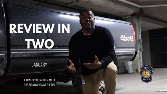 male kneeling next to truck talking