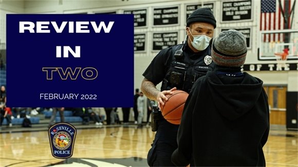 police officer holding basketball talking to kid