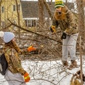 Volunteers clear brush at Central Park to clean up the community in honor of MLK day.