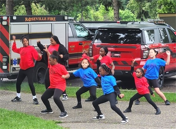 Juneteenth dancers in front of fire vehicles