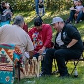 Group of Native American drummers sing and play at the 2021 Roseville Wild Rice Festival