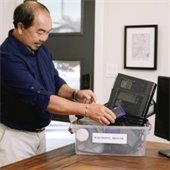 A man sorts his electronics for recycling.
