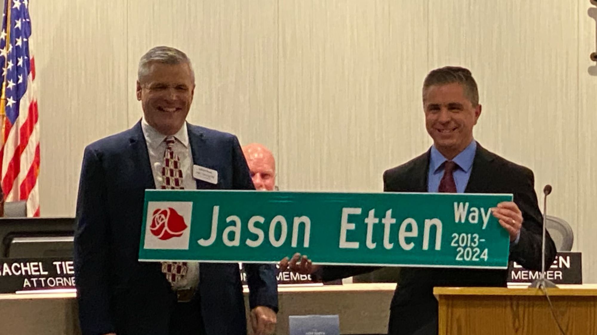Jason Etten holds a sign reading \